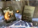 Two Holst/Bax planet-themed enamel pins from LSO Live are displayed on a card with download instructions to access digital music via your phone.